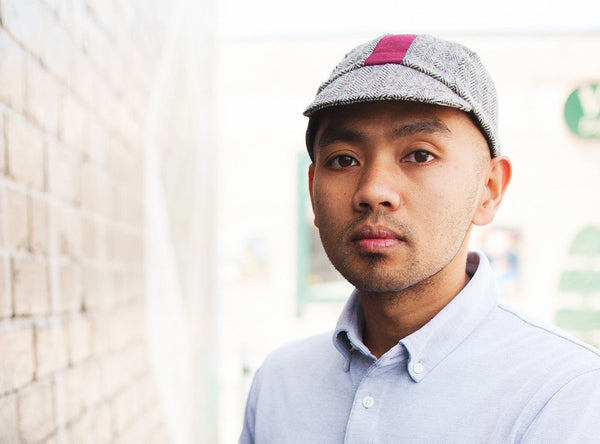 Man wearing cardinal wool herringbone cap.