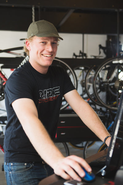 Bike shop employee wearing the Olive Cotton Velo/City cap.