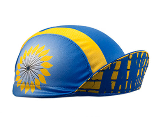 Kansas 3-Panel Technical Cycling Cap. Blue and yellow cap with sunflower imagery on the side.  Brim up angled view.
