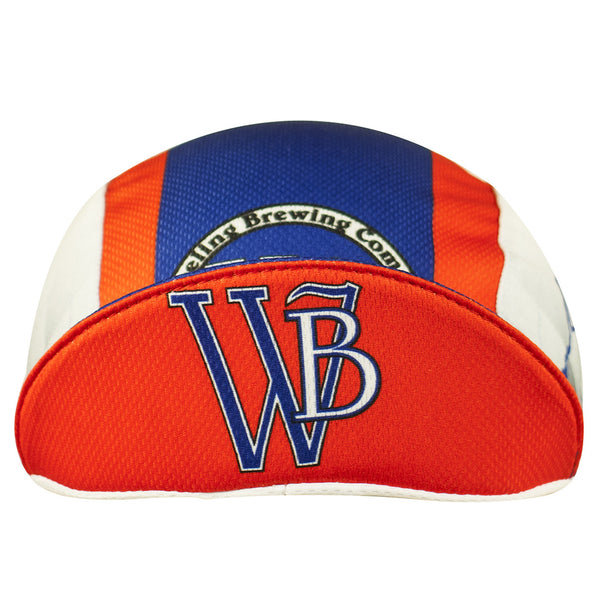 Wheeling Brewing Co. Technical 3-Panel Cycling Cap. Blue and orange cap with gray argyle pattern on side.  Wheeling brewing company imagery on side, front, and brim.  Brim up front view.